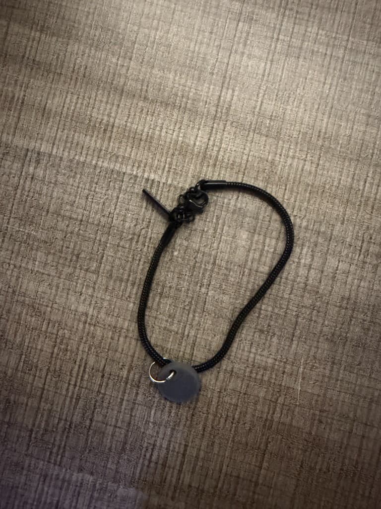 raksa NFC bracelet on wood surface